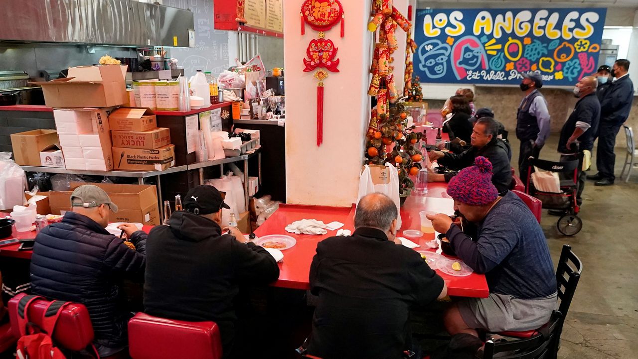 Patrons sit to eat at China Cafe on March 4, 2022, in Los Angeles. The county’s top health official said that Los Angeles County residents will no longer be required to wear masks at restaurants, bars, gyms, shops, and other businesses. (AP Photo/Damian Dovarganes)