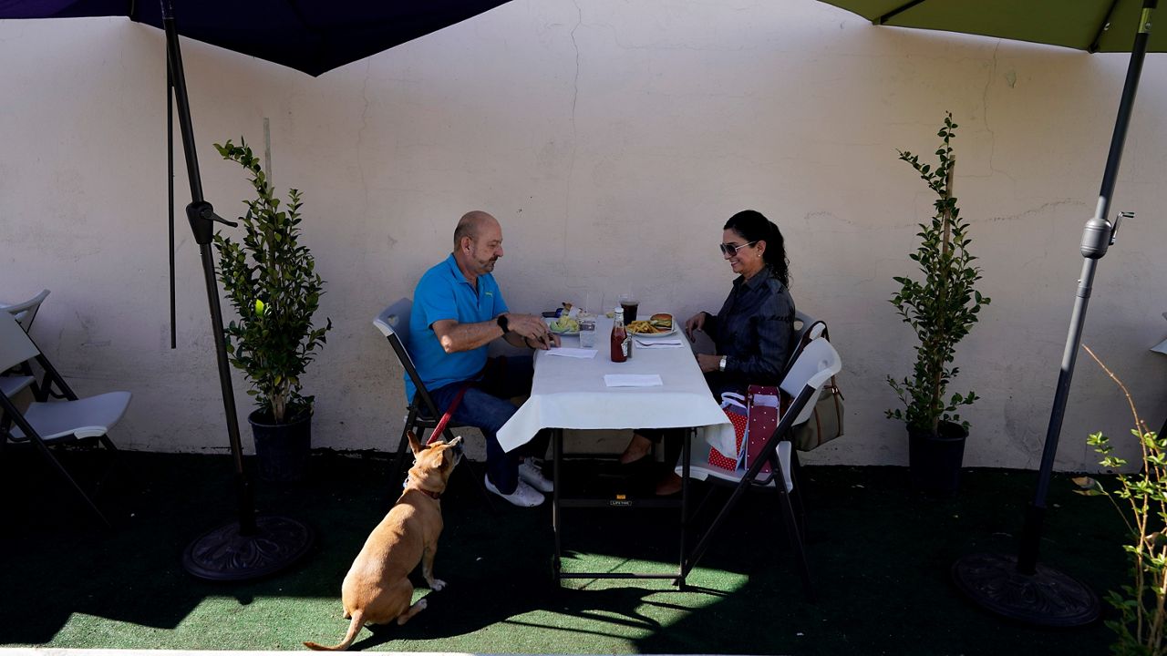 Steve Flores, left, has lunch with his cousin Carol Salter at Pie ‘N Burger on Dec. 1, 2020, in Pasadena, Calif. (AP Photo/Marcio Jose Sanchez)