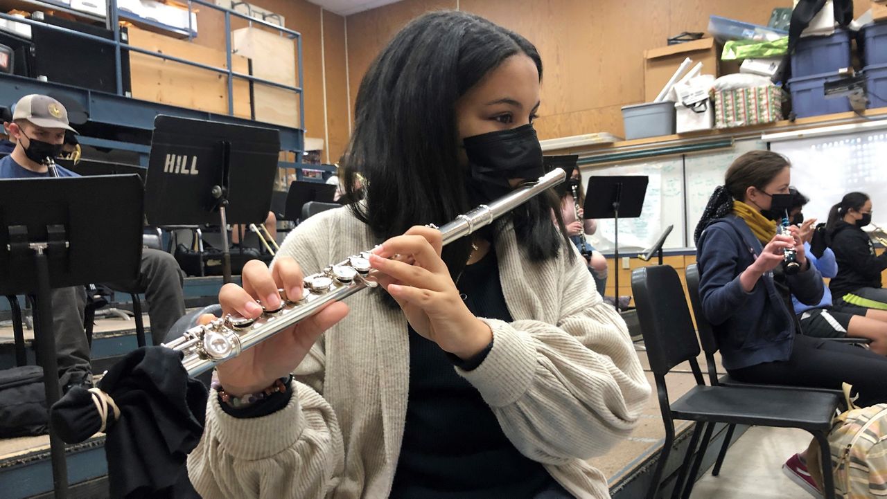 A student plays the flute while wearing a protective face mask during a music class on March 2, 2021, at the Sinaloa Middle School in Novato, Calif. (AP Photo/Haven Daily)