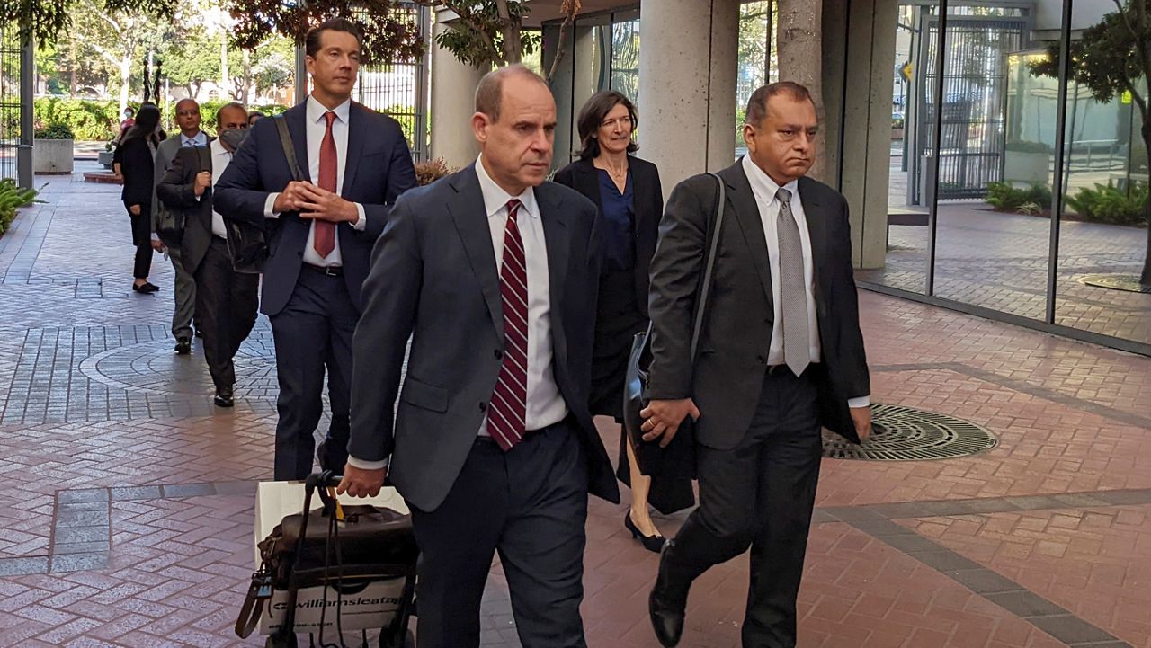 Ramesh “Sunny” Balwani, right, the former lover and business partner of Theranos CEO Elizabeth Holmes, walks into federal court on June 24, 2022, in San Jose, Calif. (AP Photo/Michael Liedtke)