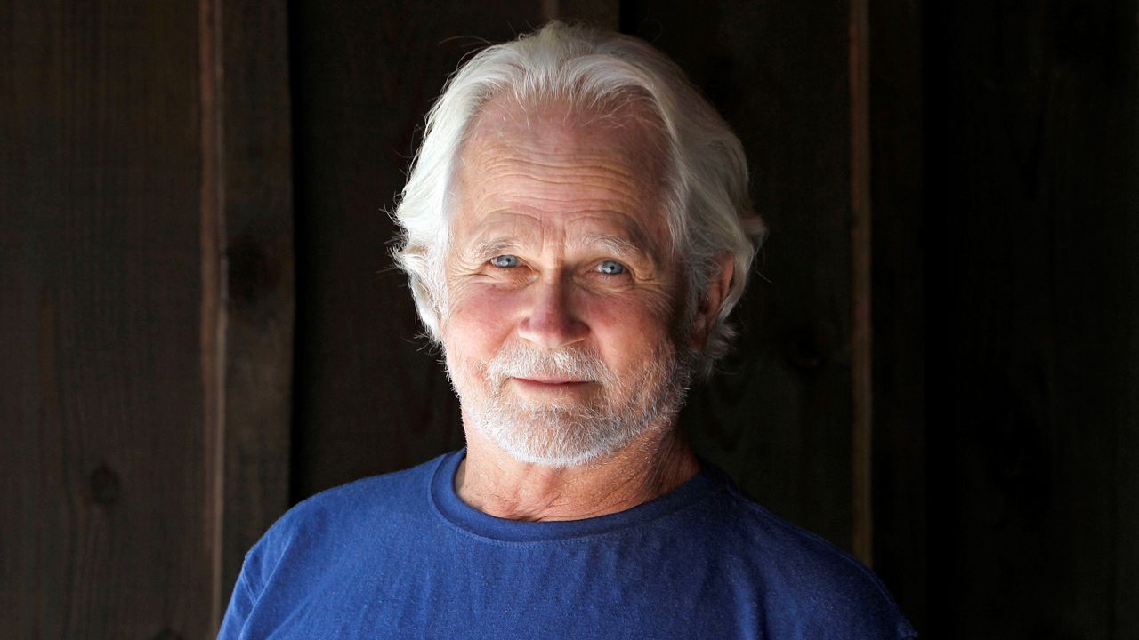 In this Sept. 18, 2012, file photo, Tony Dow, actor, director and artist, poses at his home and studio in the Topanga area of Los Angeles. (AP Photo/Reed Saxon)