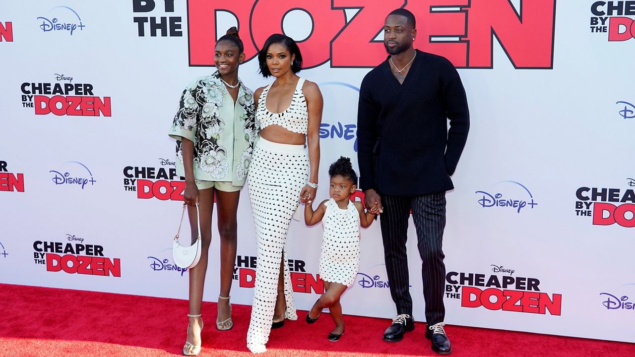 Gabrielle Union, second from left, a cast member in “Cheaper by the Dozen,” poses with her husband Dwyane Wade, far right, Wade’s daughter Zaya, far left, and Union and Wade’s daughter Kaavia James at the premiere of the film on March 16, 2022, at the El Capitan Theatre in Los Angeles. (AP Photo/Chris Pizzello)