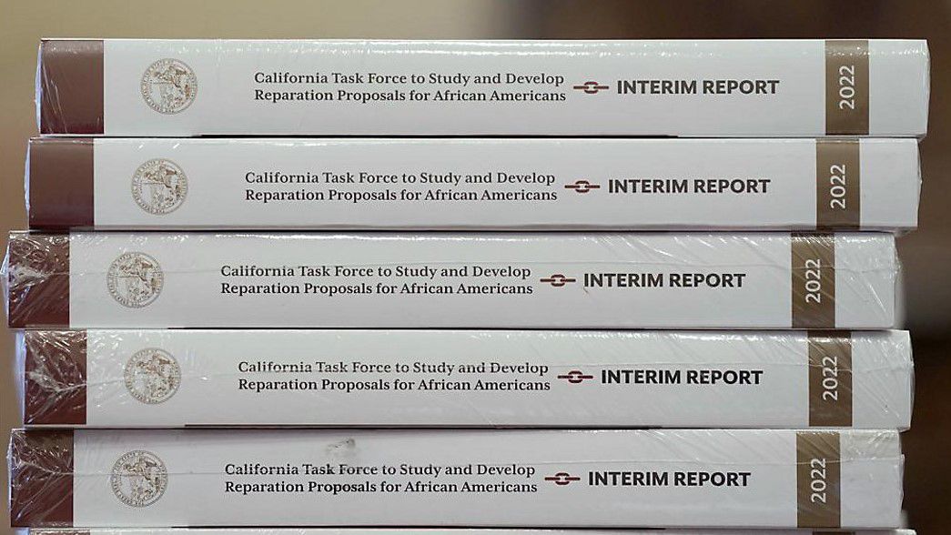 Copies of the interim report issued by California's first-in-the-nation task force on reparations for African Americans are displayed at the Capitol in Sacramento, Calif., on June 16, 2022. The Coalition for a Just and Equitable California, that pushed to create the reparations task force, is urging Democratic Gov. Gavin Newsom to veto legislation extending the deadline for the committee to complete its work. The Coalition and other organizations sent a letter to Newsom last week saying that the legislation to extend the deadline a year by task force member, Democratic Assemblyman Reginald Jones-Sawyer, will demoralize descendants of enslaved people who fear they'll never be compensated. (AP Photo/Rich Pedroncelli)