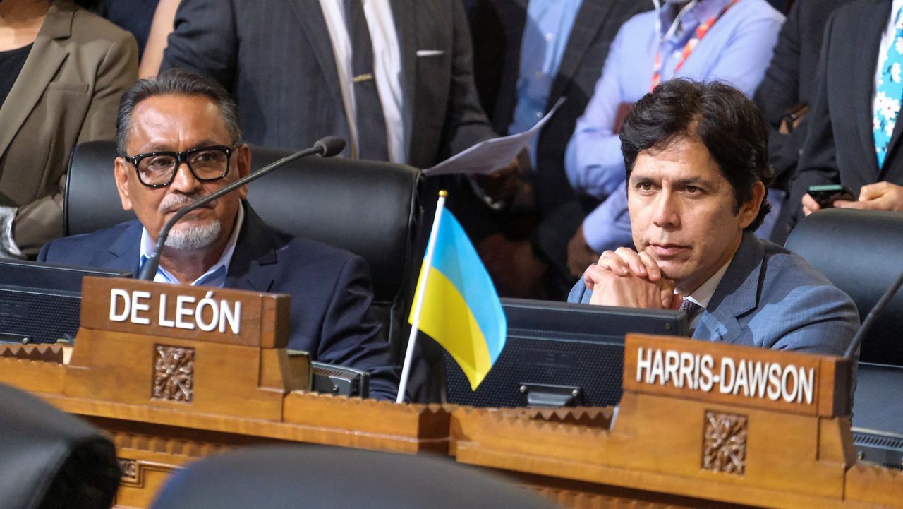 Los Angeles City Council members Gil Cedillo, left, and Kevin de Leon sit in chamber before starting the Los Angeles City Council meeting Tuesday, Oct. 11, 2022 in Los Angeles. (AP Photo/Ringo H.W. Chiu)