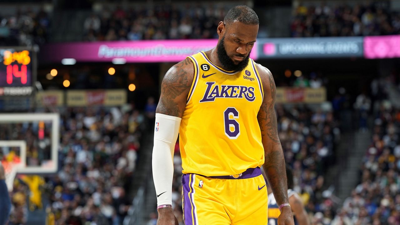 Los Angeles Lakers forward LeBron James heads to the bench in the second half of an NBA basketball game Wednesday against the Denver Nuggets in Denver. (AP Photo/David Zalubowski)