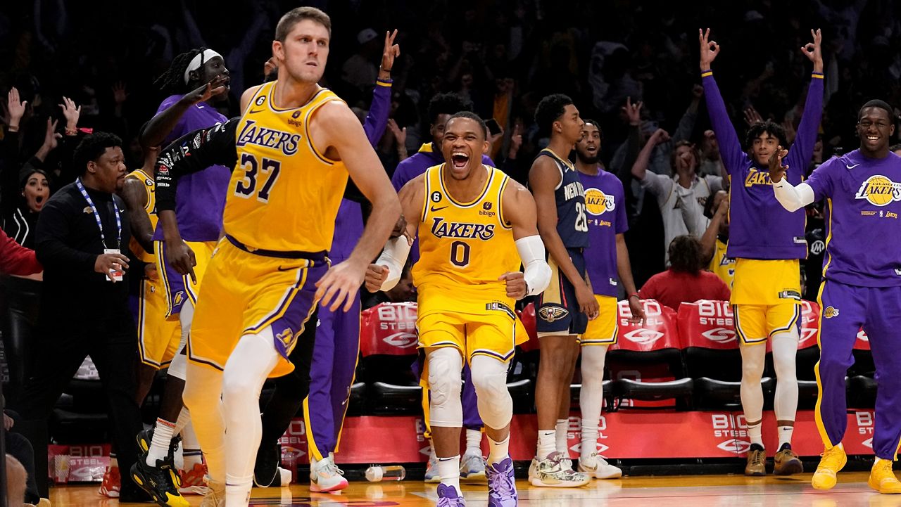 Los Angeles Lakers forward Matt Ryan, left, celebrates with guard Russell Westbrook, center, after hitting a three-point shot to tie the game and send it to overtime an NBA basketball game Wednesday against the New Orleans Pelicans in Los Angeles. (AP Photo/Mark J. Terrill)