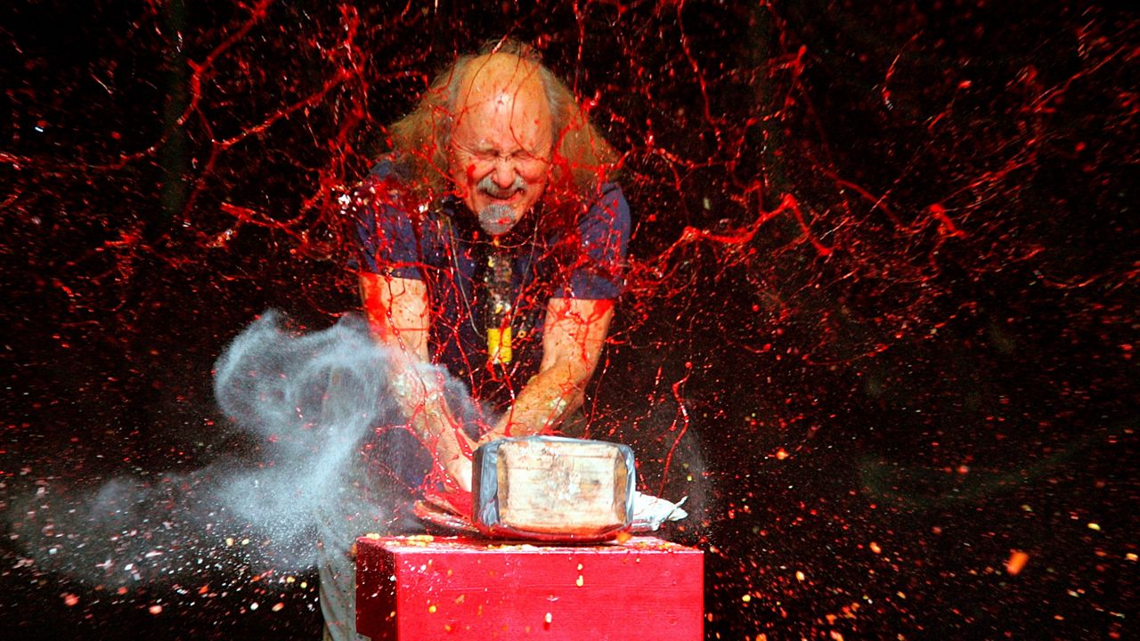 Comedian Gallagher smashes strawberry syrup and flour at the end of his performance on Nov. 18, 2006, at the Five Flags Theater in Dubuque, Iowa. (Jeremy Portje/Telegraph Herald via AP)