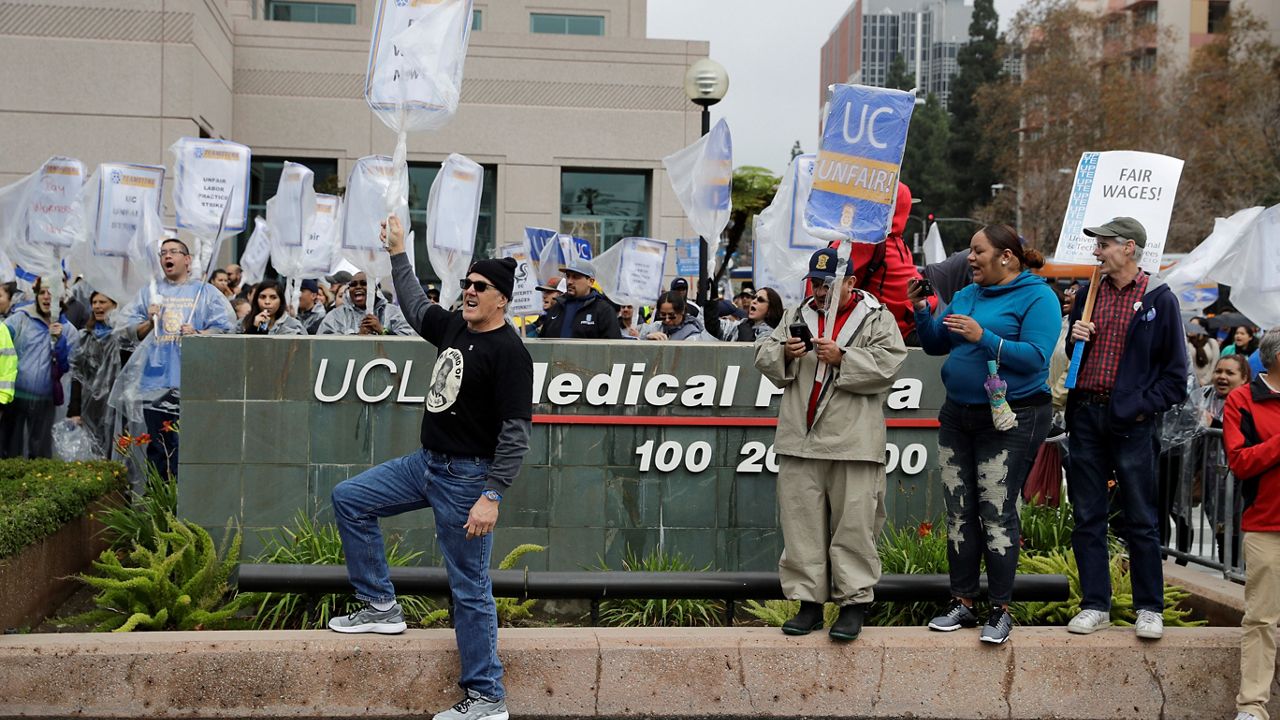University of California hospital workers protest Tuesday outside the UCLA Medical Plaza, Tuesday in Los Angeles. More than 11,000 clerical and administrative support workers are on a one-day strike against the 10-campus University of California system and medical centers. (AP Photo/Jae C. Hong)
