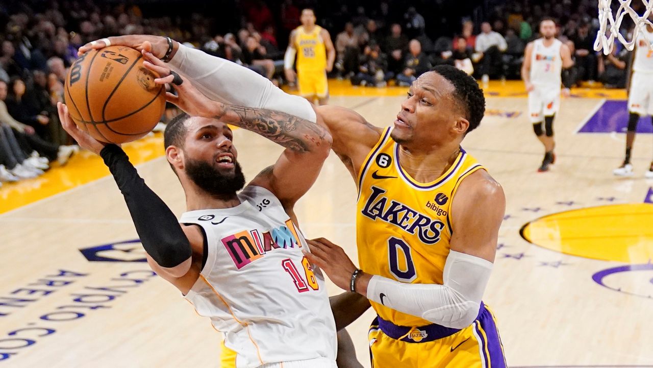 Los Angeles Lakers guard Russell Westbrook, right, blocks the shot of Miami Heat forward Caleb Martin during the first half of an NBA basketball game Wednesday in Los Angeles. (AP Photo/Mark J. Terrill)