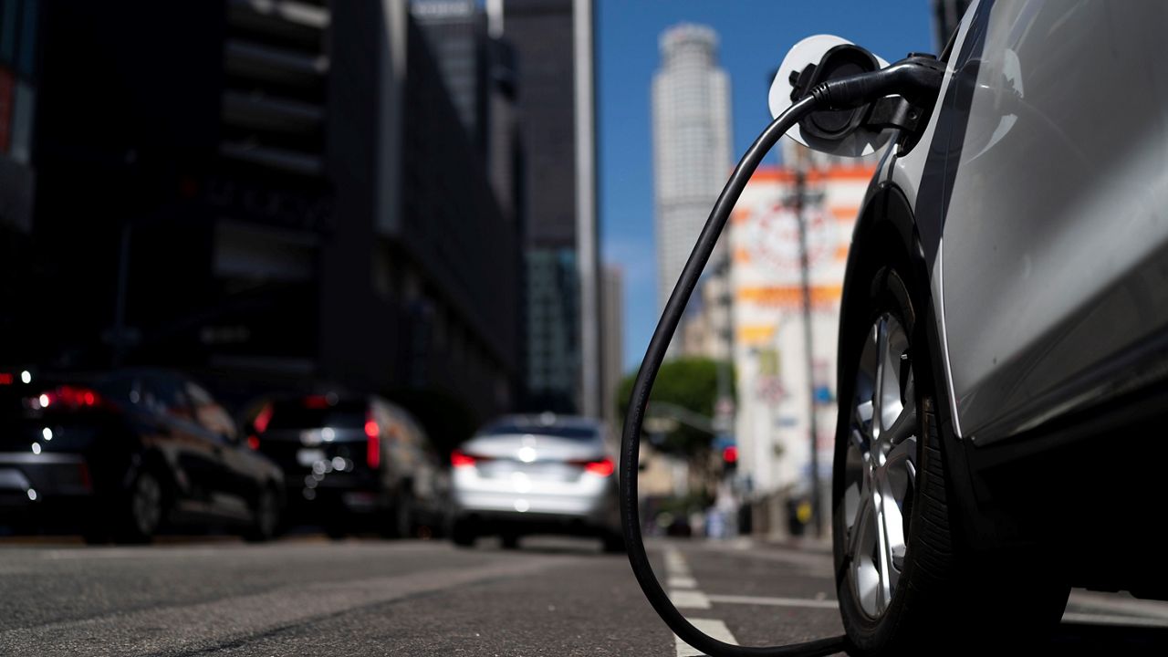 street parked car plugged into an ev charger