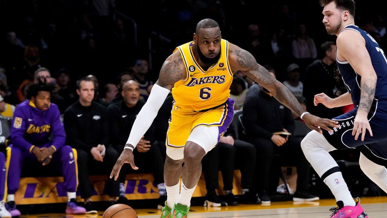 Los Angeles Lakers’ LeBron James (6) drives past Dallas Mavericks’ Luka Doncic during the first half of an NBA basketball game Thursday in Los Angeles. (AP Photo/Jae C. Hong)