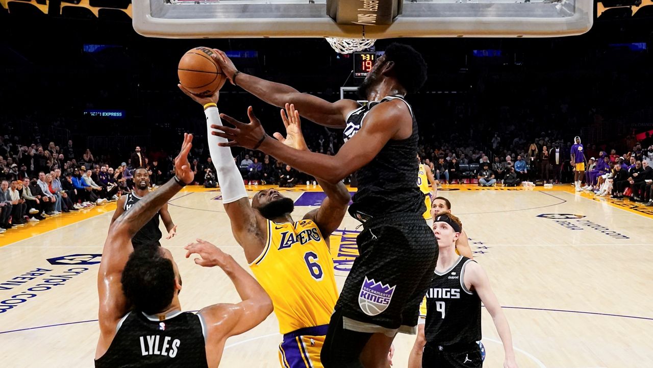 Sacramento Kings forward Chimezie Metu, right, blocks a shot by Los Angeles Lakers forward LeBron James (6) during the second half of an NBA basketball game Wednesday in Los Angeles. (AP Photo/Ashley Landis)