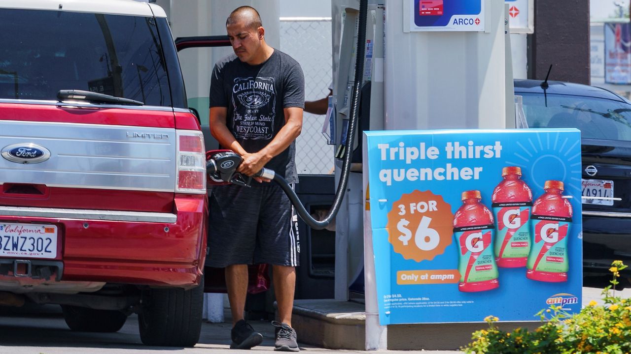 A man fuels up his vehicle at a nearby gas station. (Spectrum News)