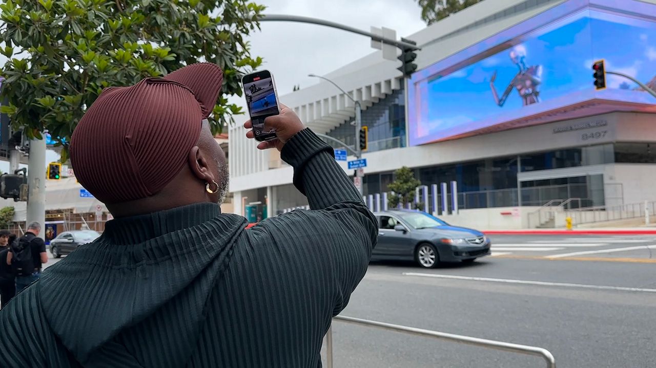 A large digital display presents an AI art installation in West Hollywood, Calif. (Spectrum News/Kristopher Gee)