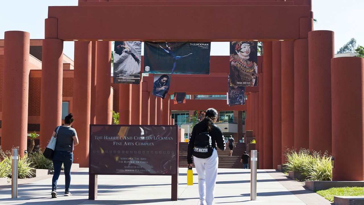 In this April 25, 2019, file photo, students walk past the Harriet and Charles Luckman Fine Arts Complex at the Cal State University, Los Angeles campus. (AP Photo/Damian Dovarganes)