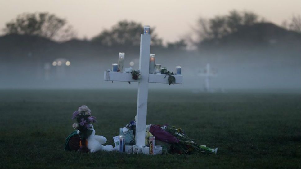 An early morning fog rises where 17 memorial crosses were placed, for the 17 deceased students and faculty from the Wednesday shooting at Marjory Stoneman Douglas High School, in Parkland Fla., Saturday, Feb. 17, 2018. As families began burying their dead, authorities questioned whether they could have prevented the attack at the high school where a gunman took several lives. (AP Photo/Gerald Herbert)