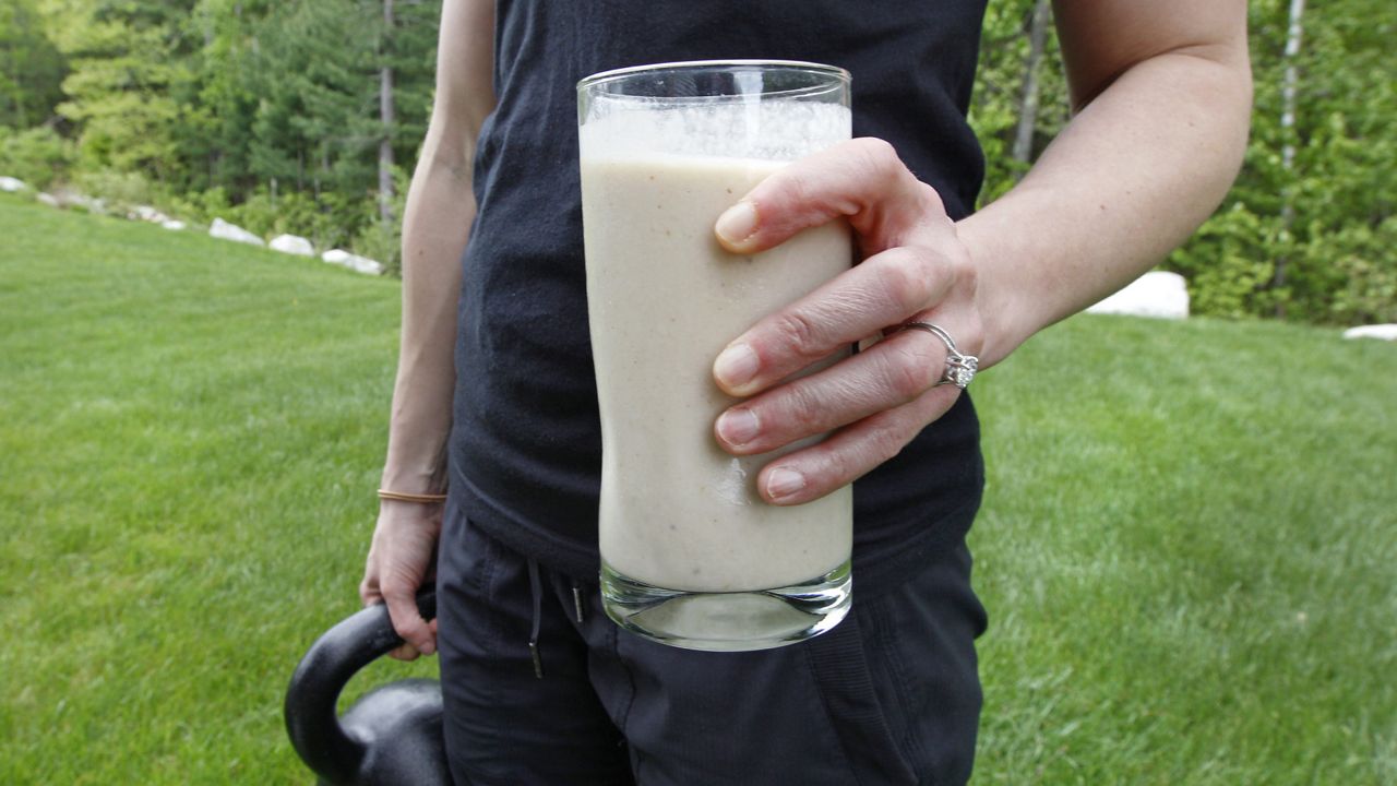 FILE: In this image taken on Tuesday, May 15, 2012, Amanda Perry holds a protein shake for lunch and a kettleball as she poses at her home in Tyngsborough, Mass. (AP Photo/Charles Krupa)