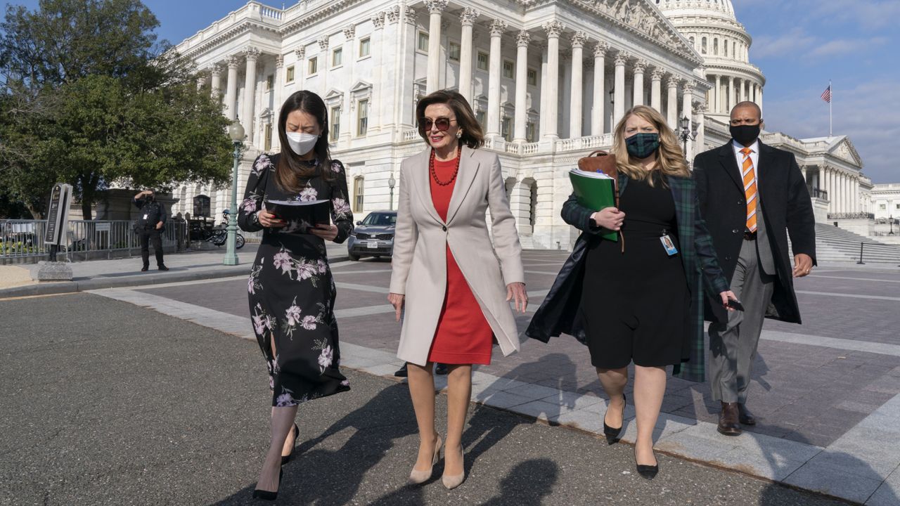 FILE: Speaker of the House Nancy Pelosi, D-Calif., second from left, walks with staff to a news conference to talk about the importance of climate change policy in President Joe Biden's domestic agenda, Wednesday, Nov. 17, 2021, at the Capitol in Washington. (AP Photo/Jacquelyn Martin)