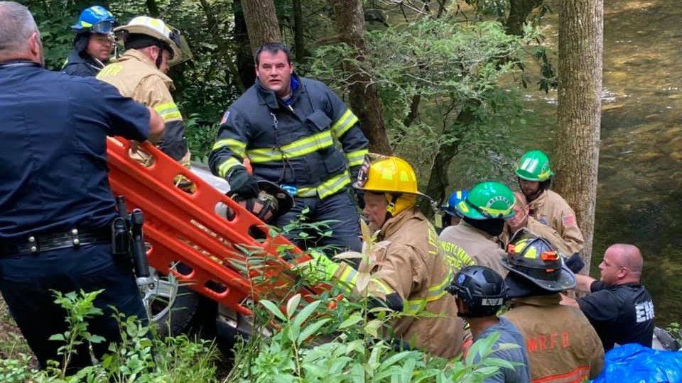 Authorities say one motorist died and three others were critically injured when a large oak tree in a national forest in western North Carolina fell into a road and onto their vehicle. (Credit: Transylvania County Rescue Squad | Facebook)