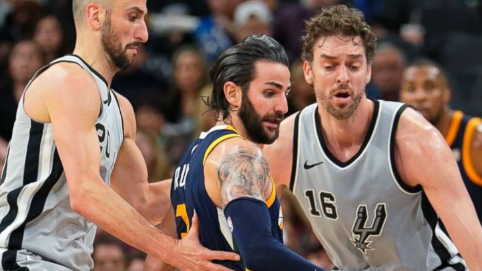 Utah Jazz' Ricky Rubio, center, loses the ball as he is guarded by San Antonio Spurs' Pau Gasol (16) and Manu Ginobili during the first half of an NBA basketball game, Saturday, Feb. 3, 2018, in San Antonio. (AP Photo/Darren Abate)