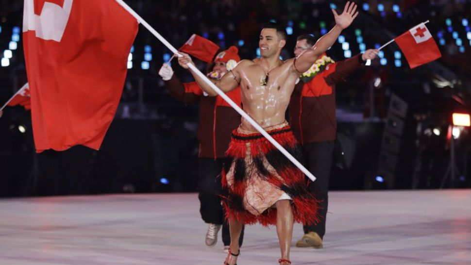 Pita Taufatofua carries the flag of Tonga during the opening ceremony of the 2018 Winter Olympics in Pyeongchang, South Korea, Friday, Feb. 9, 2018. 