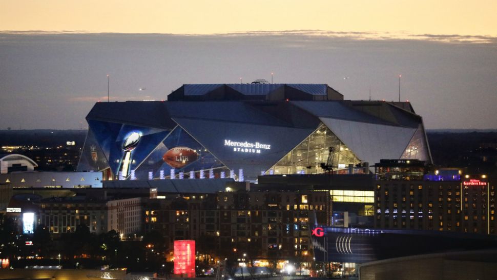 The sun sets behind Mercedes-Benz Stadium ahead of Sunday's NFL Super Bowl 53 football game between the Los Angeles Rams and New England Patriots in Atlanta, Friday, Feb. 1, 2019. (AP Photo/David Goldman)