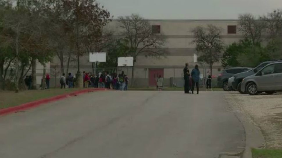 Students stand outside of the school during evacuation (Spectrum News footage)
