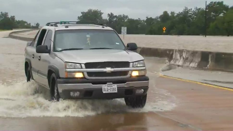Car driving through flooded roads after Hurricane Harvey (Spectrum News file photograph)