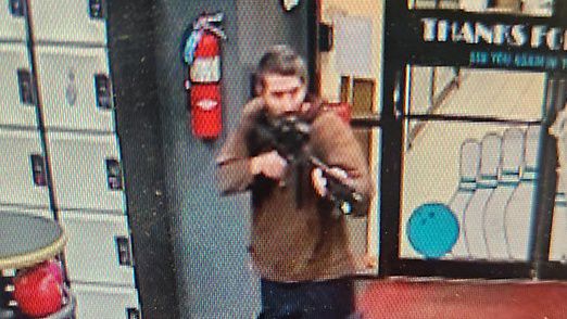 In this image taken from video released by the Androscoggin County Sheriff's Office, an unidentified gunman points a gun in Lewiston, Maine on Wednesday, Oct. 25, 2023.