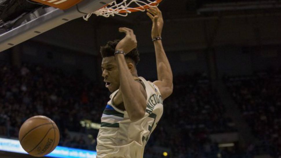 Milwaukee Bucks forward Giannis Antetokounmpo gets a slam dunk against the San Antonio Spurs during the first half of an NBA basketball game Sunday, March 25, 2018, in Milwaukee. (AP Photo/Darren Hauck)