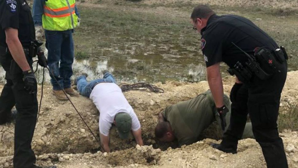 Multiple authorities work to pull a calf out of a ditch. (Photo credit: @SheriffChody)