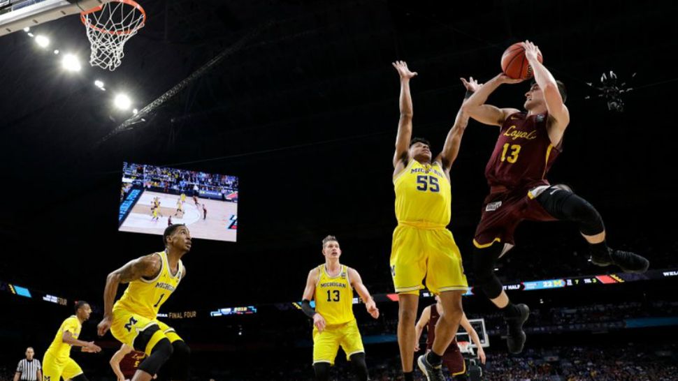 Loyola-Chicago guard Clayton Custer (13) shoots over Michigan guard Eli Brooks (55) during the first half in the semifinals of the Final Four NCAA college basketball tournament, Saturday, March 31, 2018, in San Antonio. (AP Photo/David J. Phillip)