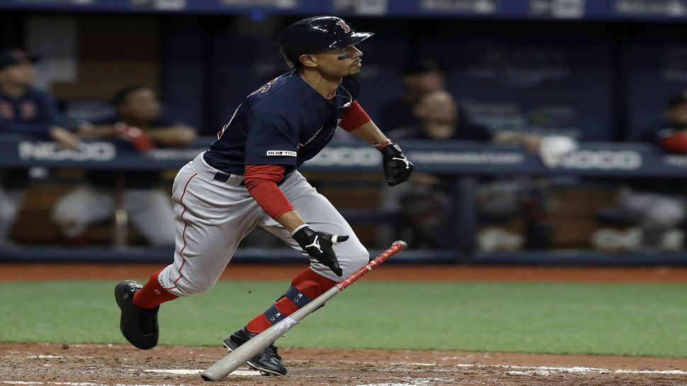 Mookie Betts watches his 8th-inning home run off of Rays reliever Diego Castillo.  Betts' drive proved to be the game-winning RBI in Boston's 6-4 win over the Rays.  (AP Photo/Chris O'Meara)