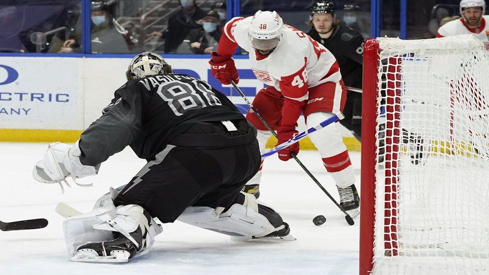 Detroit Red Wings left wing Givani Smith (48) tries to get off a shot on Tampa Bay Lightning goaltender Andrei Vasilevskiy (88) during the first period of the Lightning's 2-1 win over Detroit.  Vasilevskiy improved to 12-0 all-time vs. Detroit. (AP Photo/Chris O'Meara)