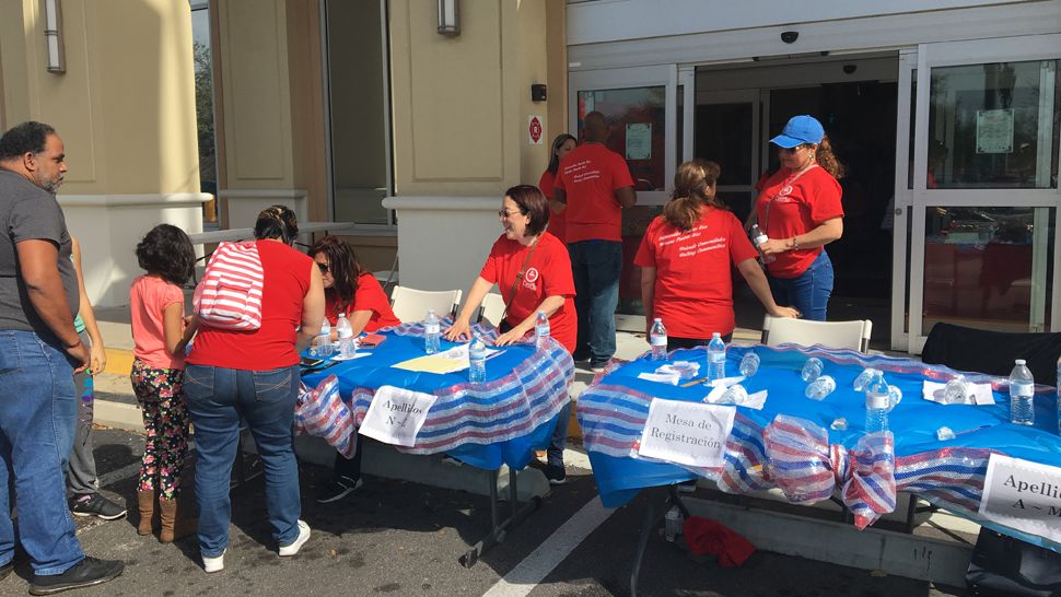 Volunteers with the Latino Coalition of Tampa Bay help migrants from Puerto Rico at a community fair. The fairs community fairs aim to help families with everything from free health screenings to employment opportunities. (Photo courtesy Latino Coalition of Tampa Bay)