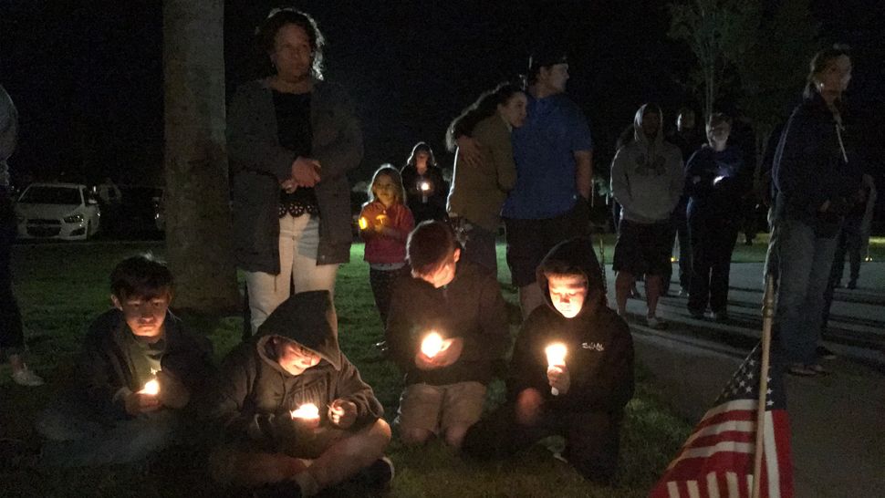 Members of the Trenton community gathering for a vigil April 20 to honor the lives of Gilchrist County Deputies Taylor Lindsey and Sgt. Noel Ramirez, who were killed at a restaurant the day before. (Laurie Davison, staff) 