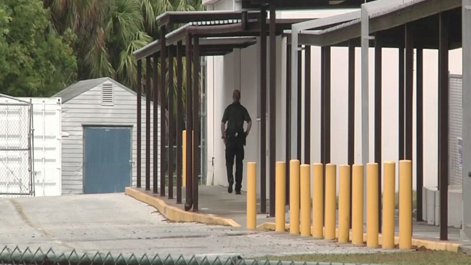 A school resource officer walks the grounds of a school in Citrus County, Thursday, April 26, 2018. (Kim Leoffler, staff)