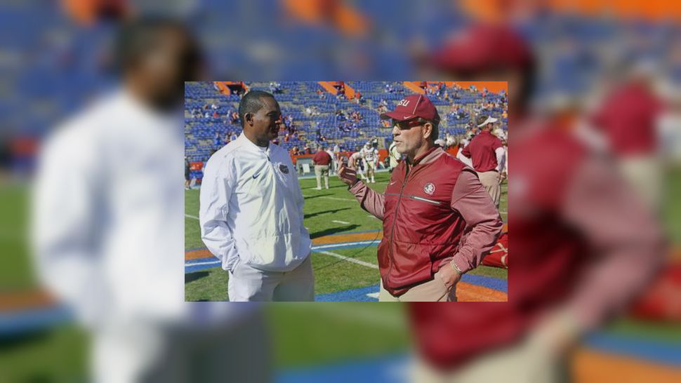 Florida interim head coach Randy Shannon, left, greets Florida State head coach Jimbo Fisher at midfield before an NCAA college football game, Saturday, Nov. 25, 2017, in Gainesville, Fla. (AP Photo/John Raoux)
