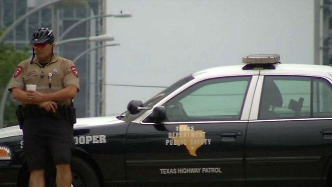 FILE - A DPS Trooper leaning against a DPS vehicle. 