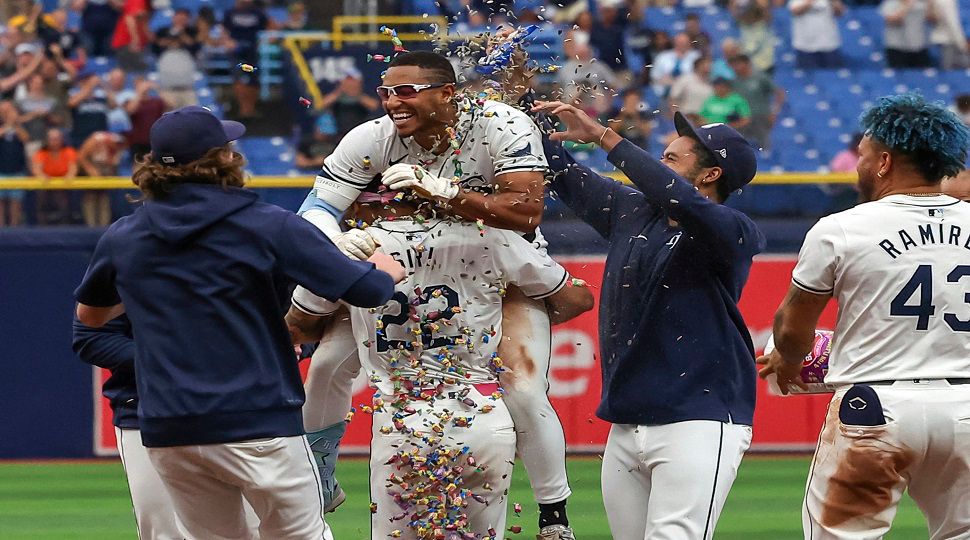 Tampa Bay Rays' Richie Palacios, center, is lifted by Jose Siri after Palacios hit the game-winning RBI single in the 12th inning of a baseball game against the Oakland Athletics, Thursday, May 30, 2024, in St. Petersburg, Fla. The Rays won 6-5 in 12 innings. (AP Photo/Mike Carlson)