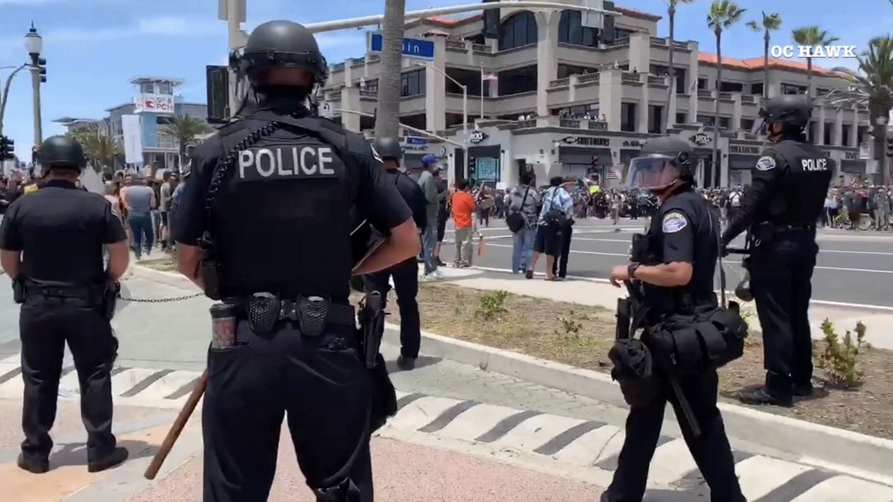 A Huntington Beach demonstration has been deemed an unlawful assembly by police as the gathering drew more than 500 people. (Courtesy: OC Hawk)