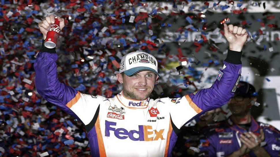 In this file photo from February of 2020, Denny Hamlin celebrates in Victory Lane after winning the Daytona 500.  Hamlin took the checkered flag in the final race of NASCAR's iRacing Pro Invitational Series on a simulated throwback of North Wilkesboro Speedway.  (AP Photo/John Raoux, File)