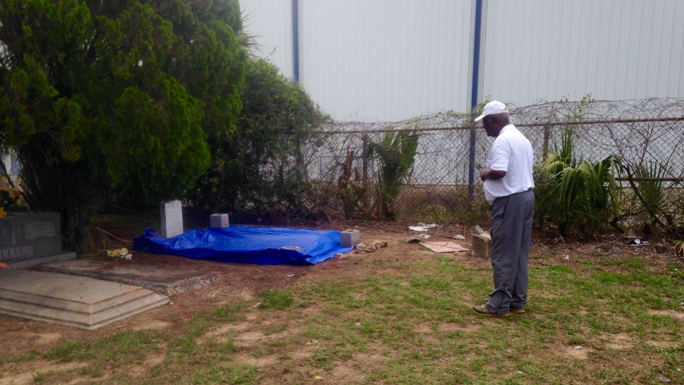 Otto Brown, brother-in-law of deceased Army veteran Willie Graham, looks at Graham's grave at Palm Cemetery in Bartow, Tuesday, May 15, 2018. The clothes Graham was buried in when he was laid to rest in 1999 were removed from his body sometime last week, according to Bartow Police. (Josh Rojas, staff)