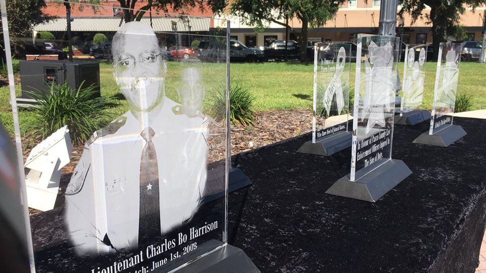 Plaques honoring local fallen officers, including Capt. Charles Bo Harrison of the Pasco County Sheriff’s Office, were on display at Pasco County's annual Law Enforcement Memorial Service, Friday, May 4, 2018. (Sarah Blazonis, staff)