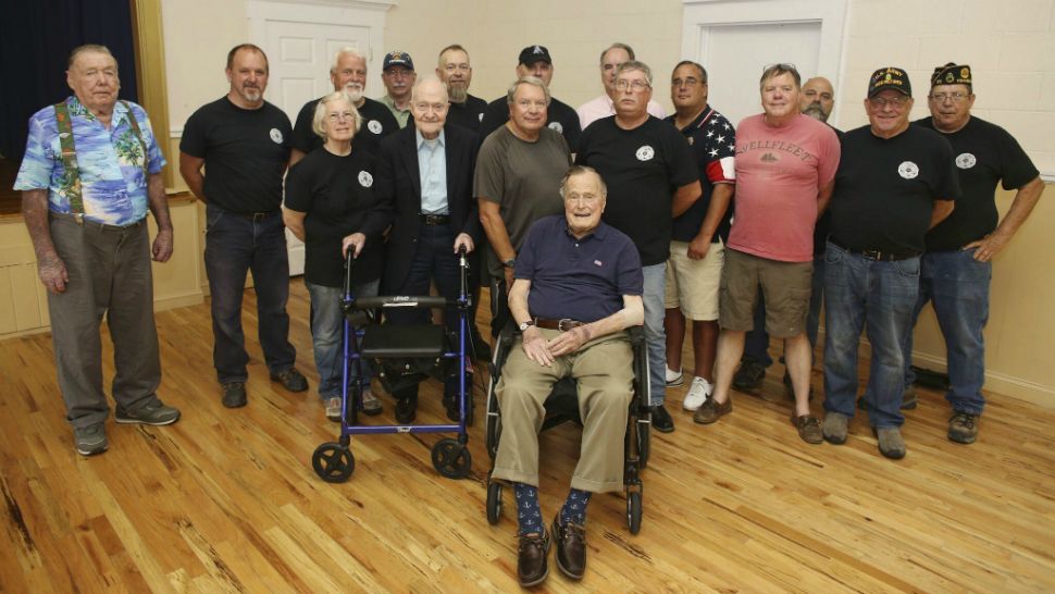 Bush posing with veterans during the monthly pancake breakfast at the American Legion Post 159 in Kennebunkport, Maine, on Saturday, May 26, 2018. (Office of former President George H.W. Bush via AP)