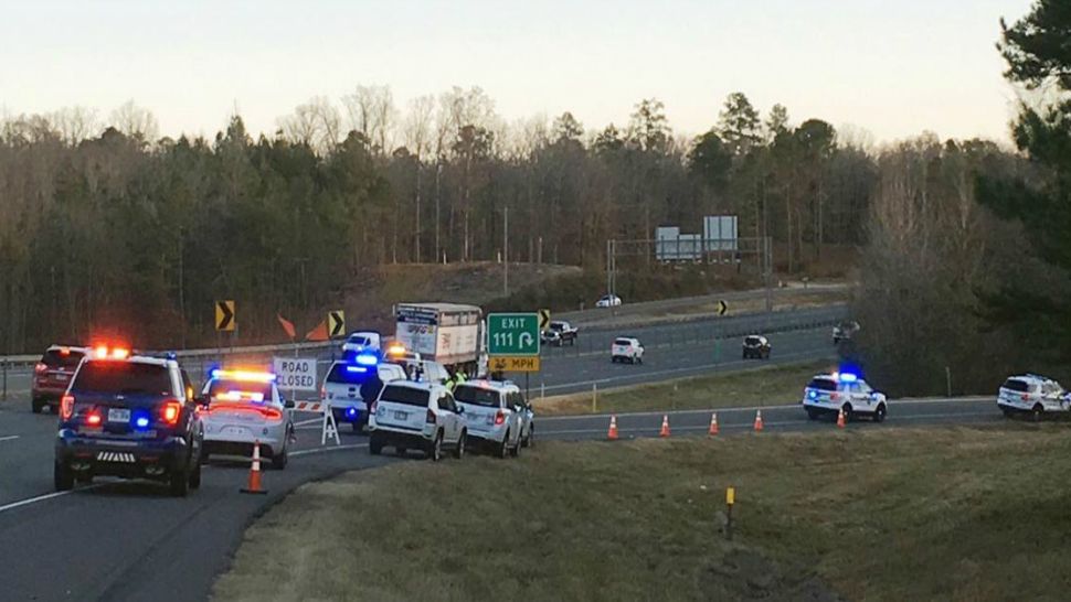 Emergency vehicles are parked along Interstate 30 near the scene where a charter bus that was carrying a youth football team from Tennessee crashed early Monday, Dec. 3, 2018, near Benton, Ark. The bus was carrying the team from Texas to Memphis, Tenn. (Josh Snyder/The Arkansas Democrat-Gazette via AP)