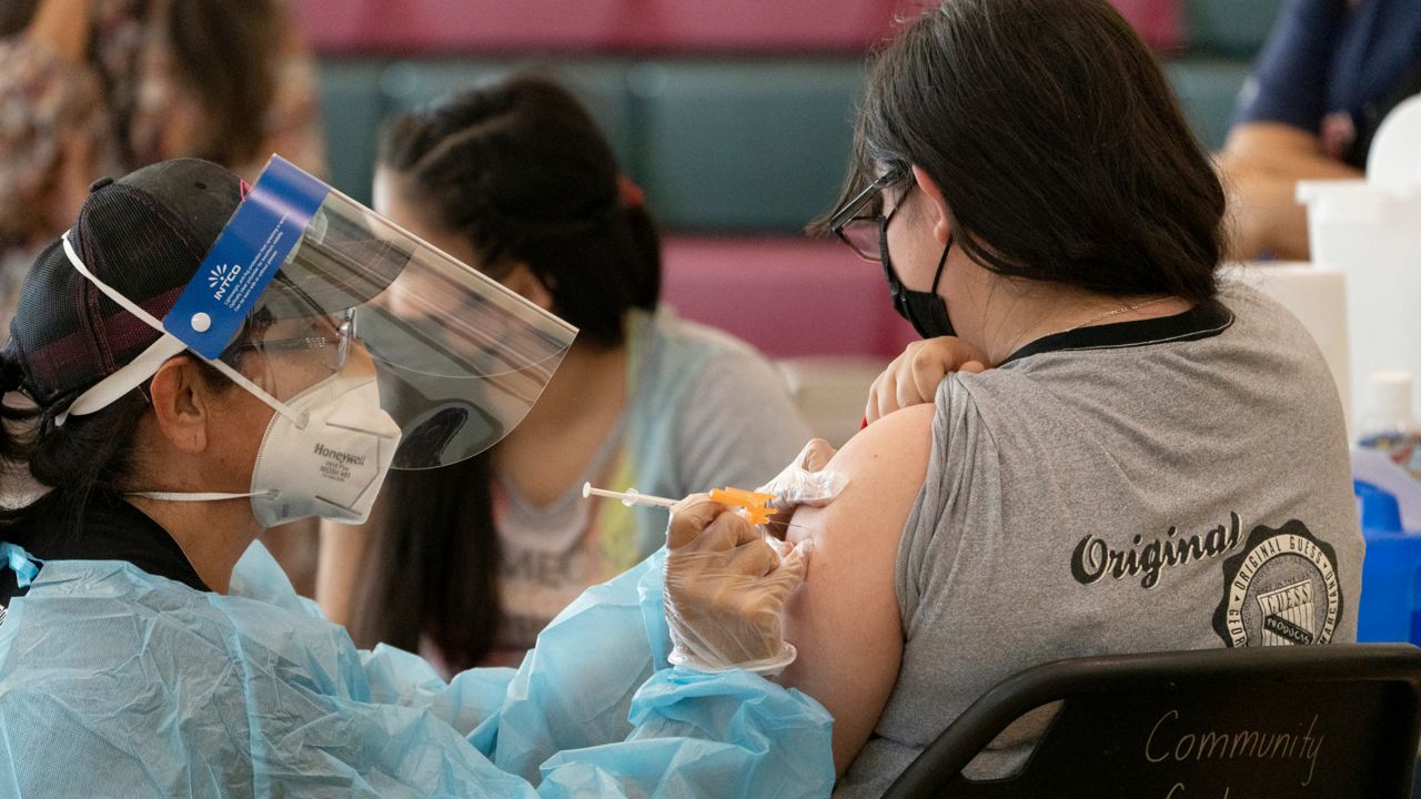 COVID-19 vaccinations at Esteban E. Torres High School in Los Angeles (AP Photo/Damian Dovarganes)