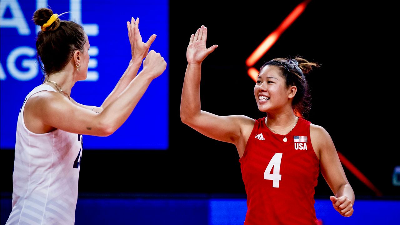 Team USA's women's national volleyball players Kelsey Robinson, left, and Justine Wong-Orantes celebrate with a high-five against Japan at the FIVB Volleyball Women's Nations League tournament in Rimini, Italy. (Courtesy Team USA)