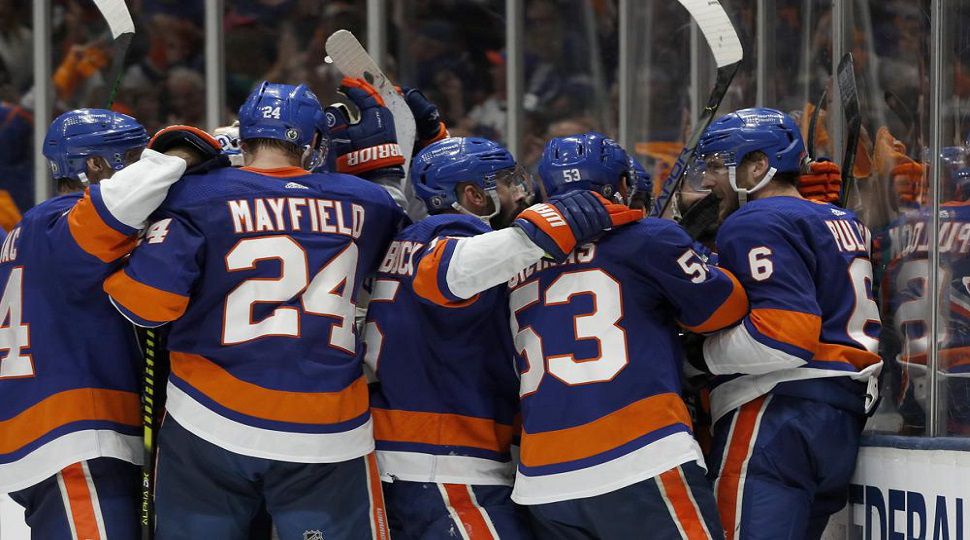 New York Islanders defenseman Ryan Pulock (6) and teammates celebrate a 3-2 win over the Tampa Bay Lightning in Game 4 of an NHL hockey Stanley Cup semifinal Saturday, June 19, 2021, in Uniondale, N.Y. (AP Photo/Jim McIsaac)