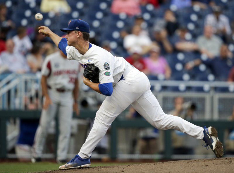 Florida ace Brady Singer throws against Arkansas in the first inning of an NCAA College World Series baseball game in Omaha, Neb., Friday, June 22, 2018. (AP Photo/Nati Harnik)